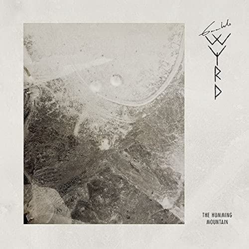 CD cover with textured grayscale landscape and runic symbols.