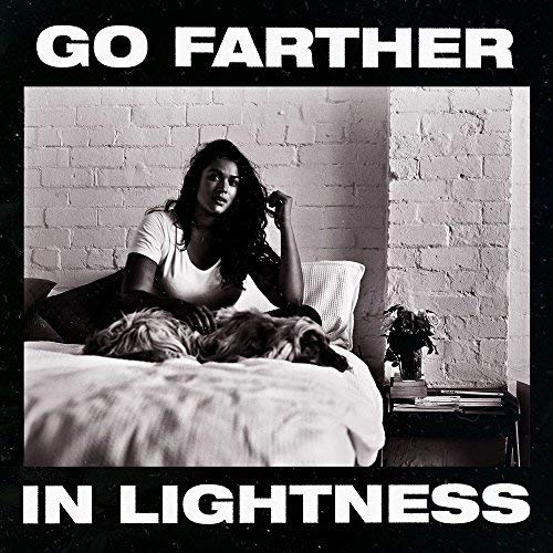 Album cover: woman with dog on a bed, black and white.