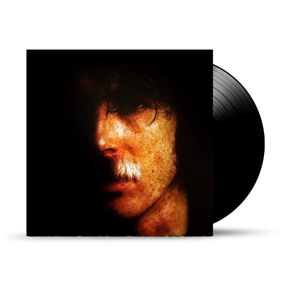 Vinyl record with album cover featuring a close-up portrait of a man.