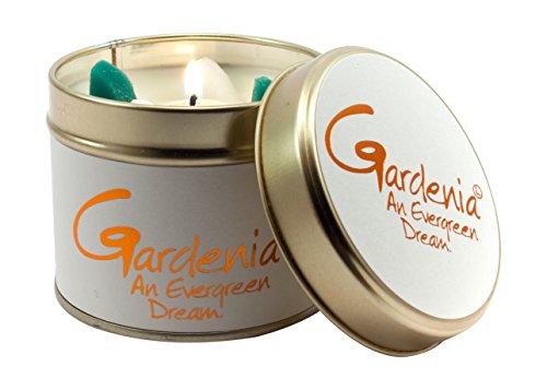 White tin candle with orange "Gardenia" text and a lit wick.