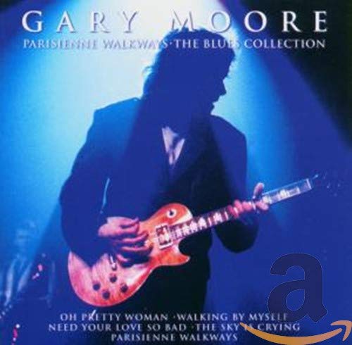 Gary Moore performing on stage with his electric guitar in a blue spotlight.