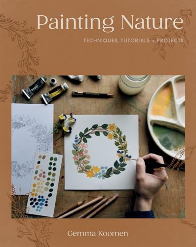 Book cover with painting supplies and a floral wreath sketch.