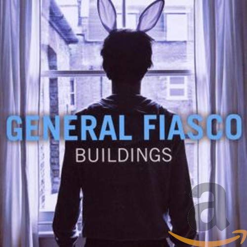 Silhouette of a person wearing bunny ears standing by a window overlooking buildings.