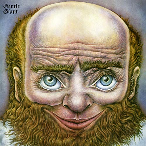 Close-up of a bearded man’s face with large, expressive eyes.
