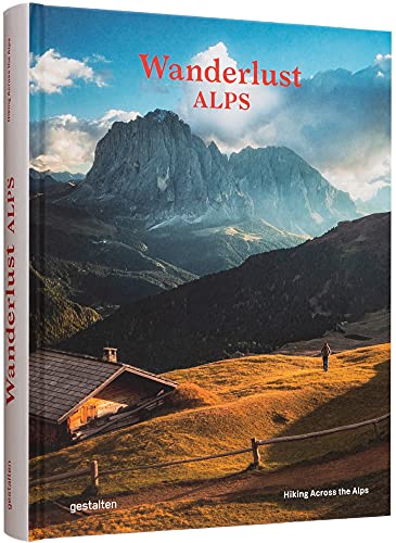 Hardcover book cover featuring a mountain landscape, a small wooden cabin, and a hiker.