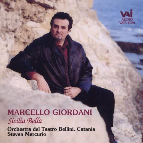 CD cover featuring Marcello Giordani, a tenor, seated against a rock face.