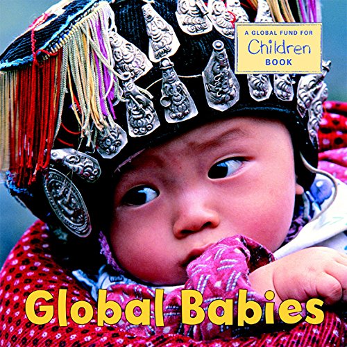 A baby wearing an ornate black and silver headpiece with colorful tassels.