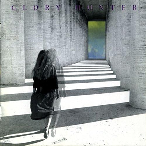 CD cover: woman ascending stark concrete stairs, blurred figure.