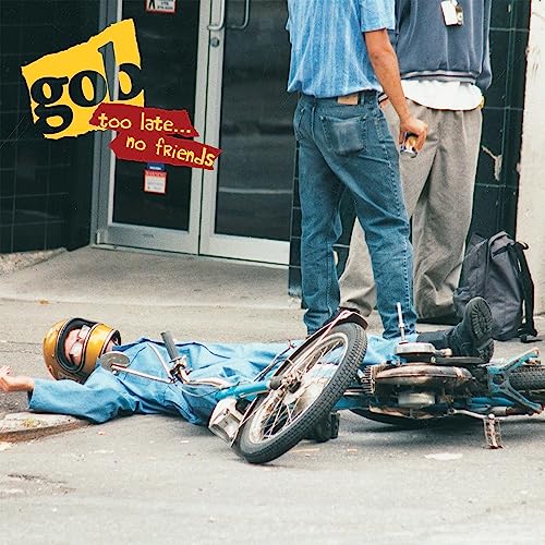 Album cover: person lying near a crashed bicycle, street scene.