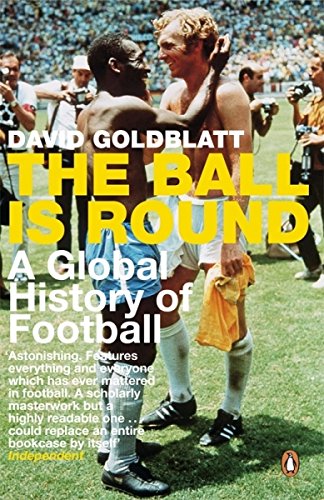 Two shirtless football players embrace on a field surrounded by photographers on the book cover.