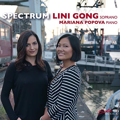 "CD cover featuring two women standing together with industrial background."