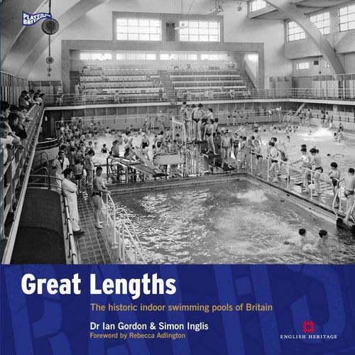Black and white photo of a crowded, historic indoor swimming pool.