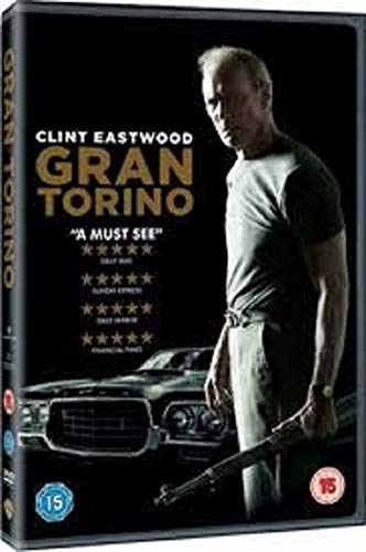 Clint Eastwood stands holding a rifle next to a car on the Gran Torino DVD.