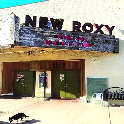 Vintage theater marquee reading "New Roxy" with album title overlay.