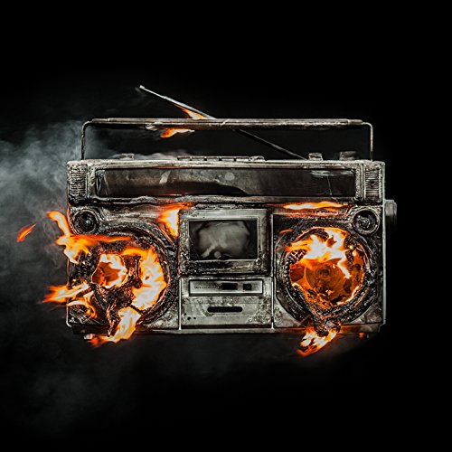 "Burning vintage boombox with flames on speakers, smoke, and a black background."