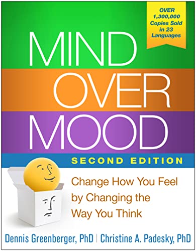 Book cover for Mind Over Mood with a yellow smiley face in a box.