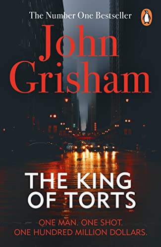 Book cover: "The King of Torts" by John Grisham, city skyline background.