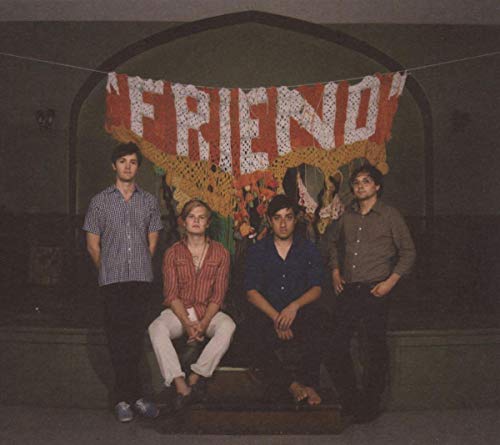 Grizzly Bear band portrait with a crocheted "FRIEND" banner backdrop.