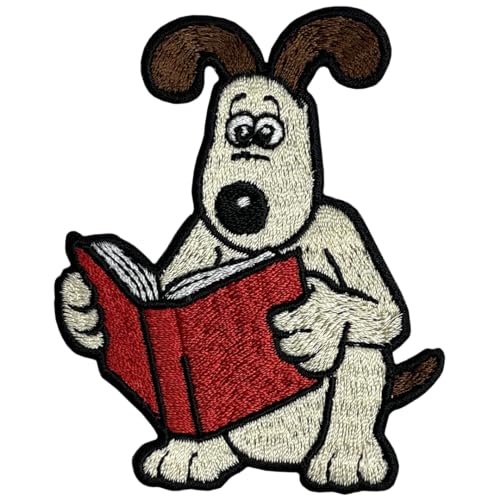 Embroidered patch of Gromit reading a red book, facing forward.