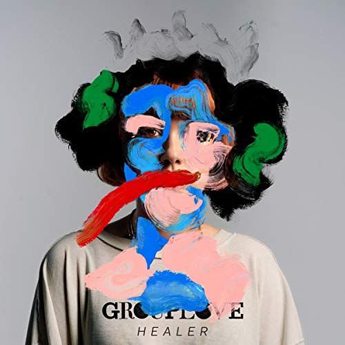 The image is a CD cover for the album "Healer" by Grouplove. A concise description of the image is: A person with a white t-shirt and abstract face paint.
