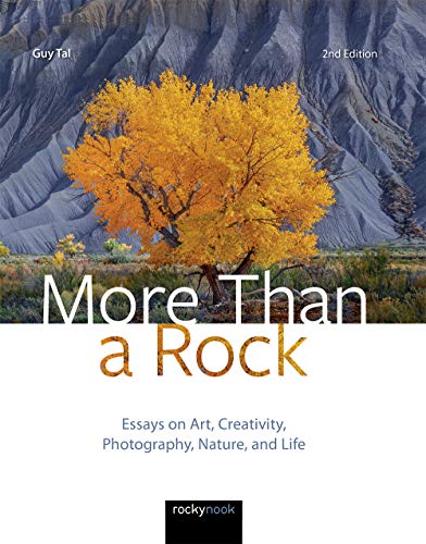 Book cover with a golden tree against layered, textured mountains.
