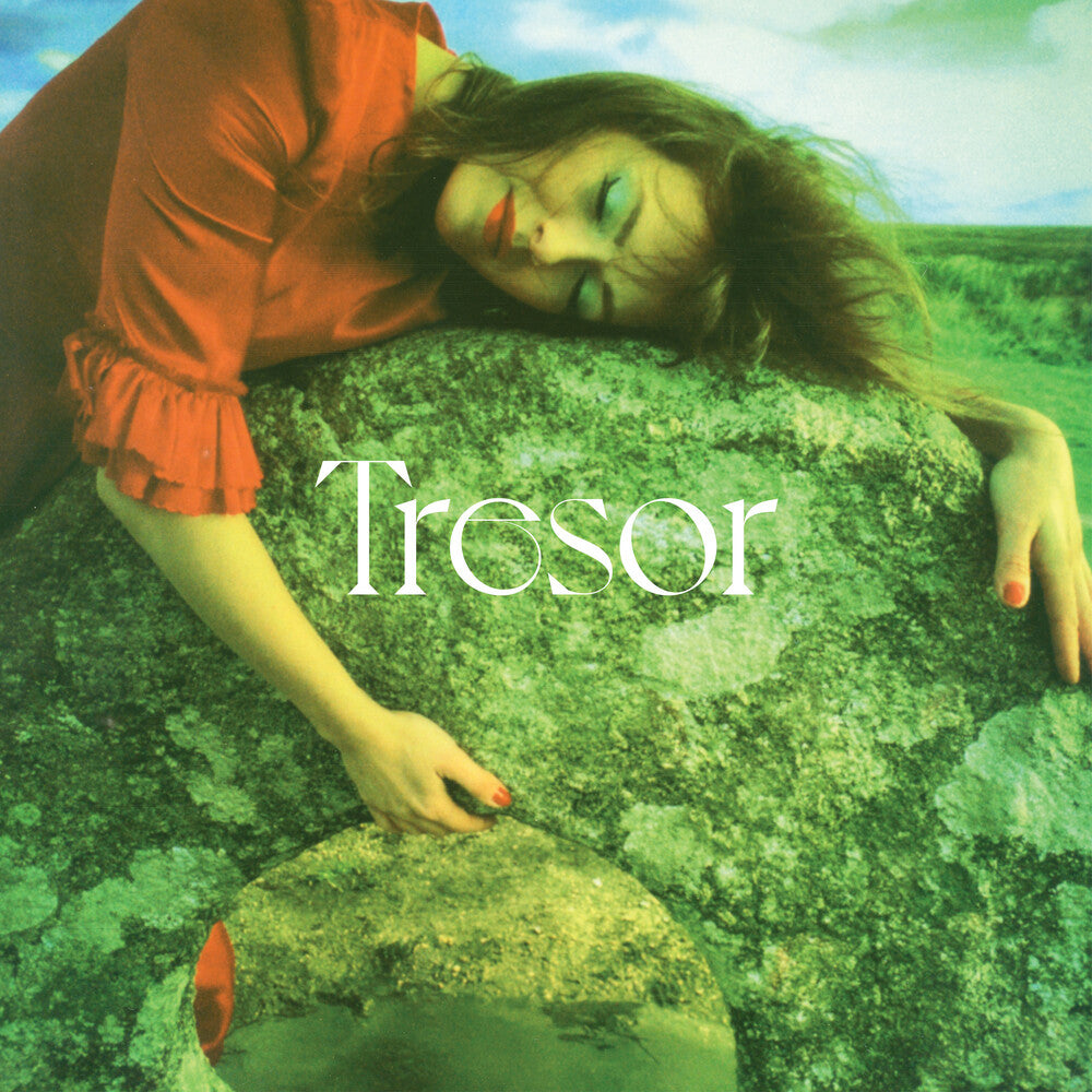 Woman with closed eyes rests on a mossy rock, album cover.