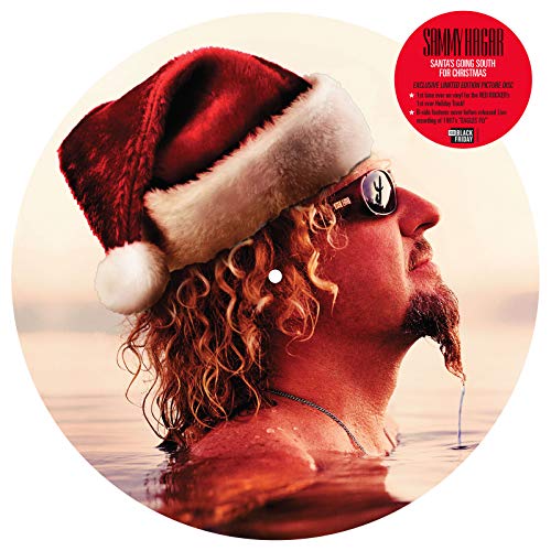 Sammy Hagar in a Santa hat, waist-deep in ocean water.