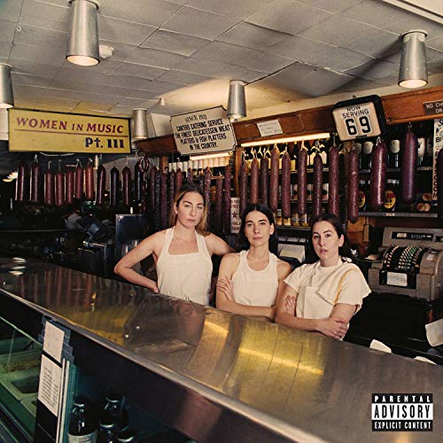 Haim’s “Women In Music Pt. III” CD cover featuring three women in a butcher shop.