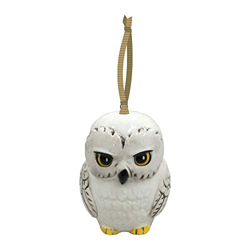 White owl ornament with yellow eyes and feet, hanging from gold ribbon.