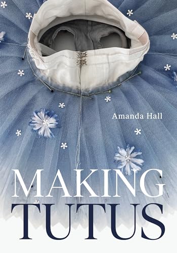 Book cover featuring a blue tulle tutu with white flower embellishments and sewing pins.