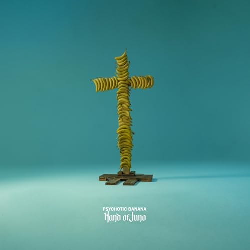Banana cross on a wooden base against a teal background.