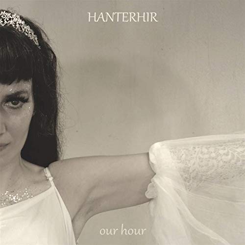CD cover: woman with dark hair, tiara, and white fabric.
