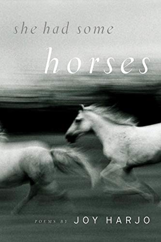 BlackSlightly blurred black and white book cover featuring running horses and title text.