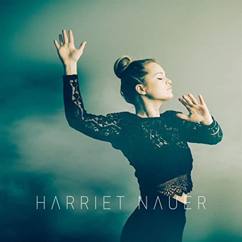 Woman with raised arms, dark clothing, and album title text.