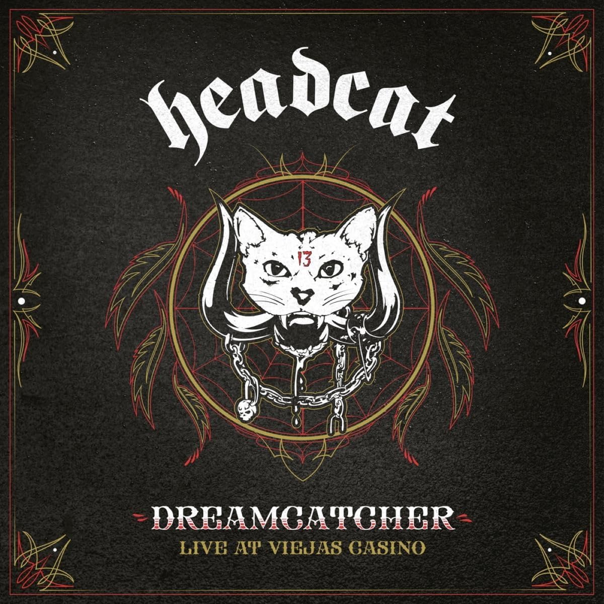 "Album cover with a white cat's head surrounded by feathers and a spider web."