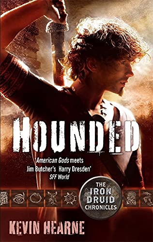 Book cover: Man with sword, title "Hounded" in large white letters.