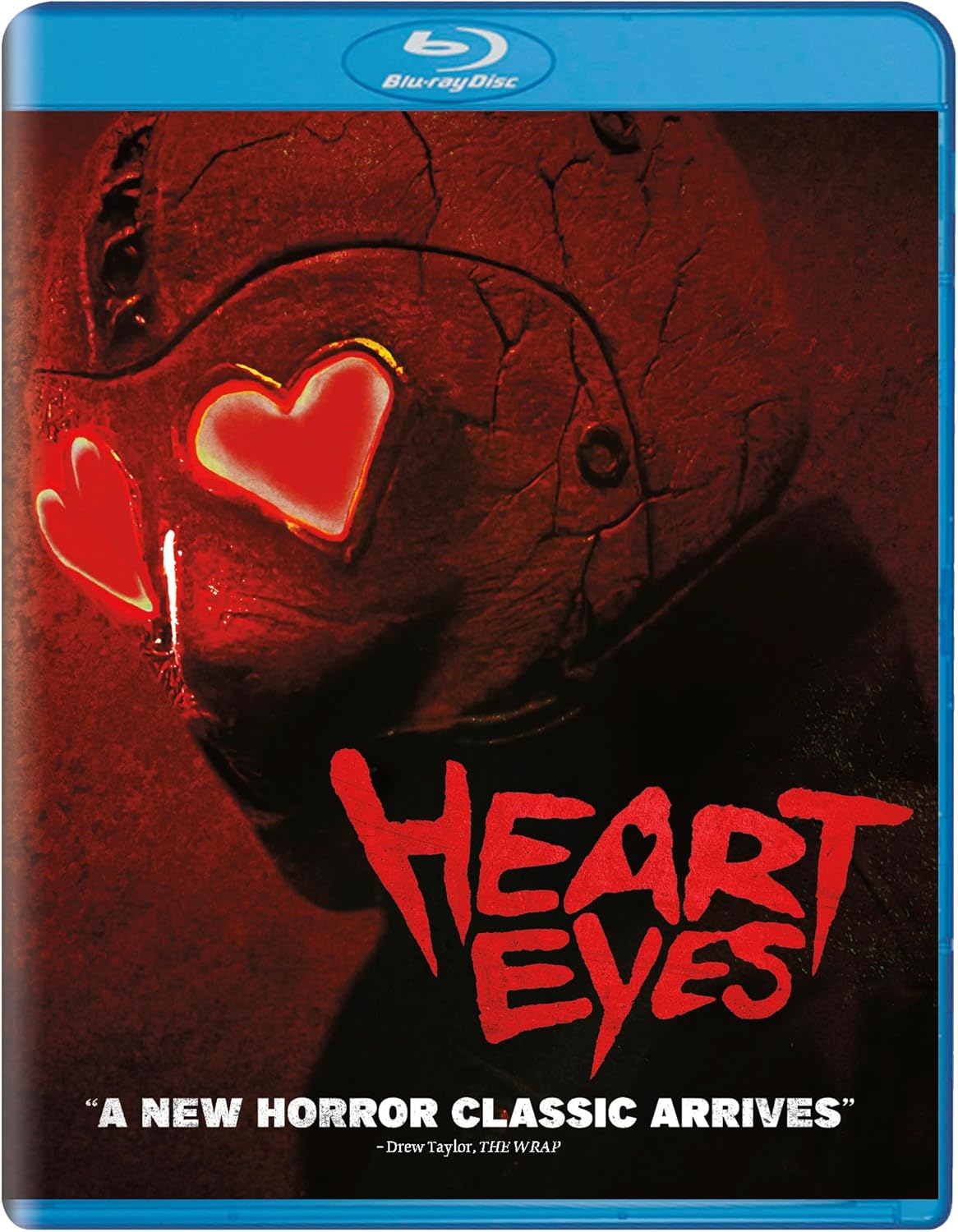 Blu-ray cover featuring a masked figure with glowing heart-shaped eyes in red lighting.