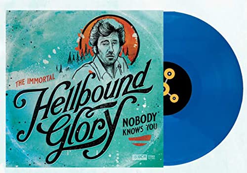 Vinyl record with turquoise color and album cover featuring a portrait.