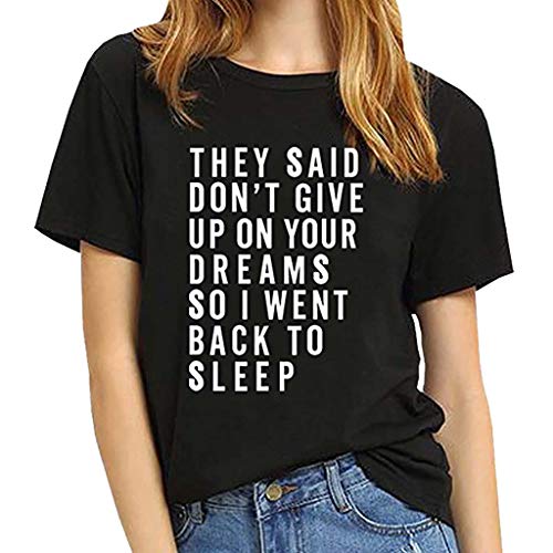 Woman wearing a black t-shirt with white text about dreams.