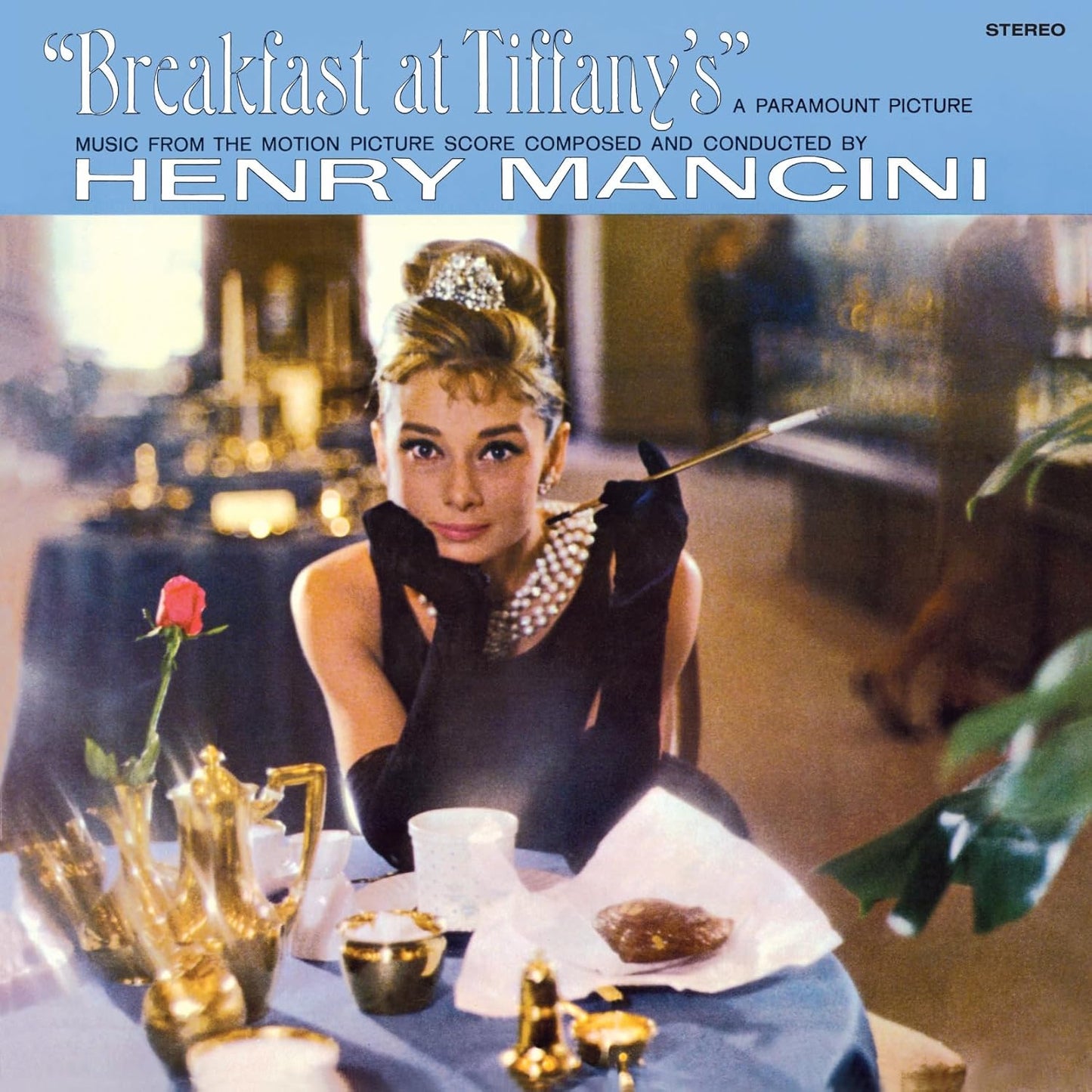 Audrey Hepburn on “Breakfast at Tiffany’s” vinyl record cover, pink and turquoise.
