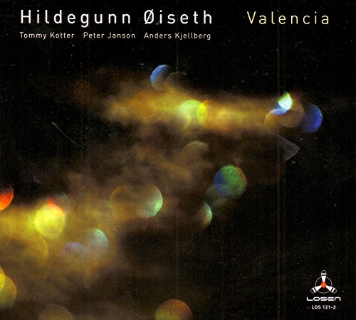 "CD album cover with blurry, colorful lights on a black background, featuring artist and title."
