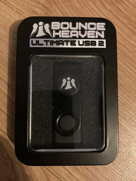 Black USB drive in a clear plastic case with a logo.