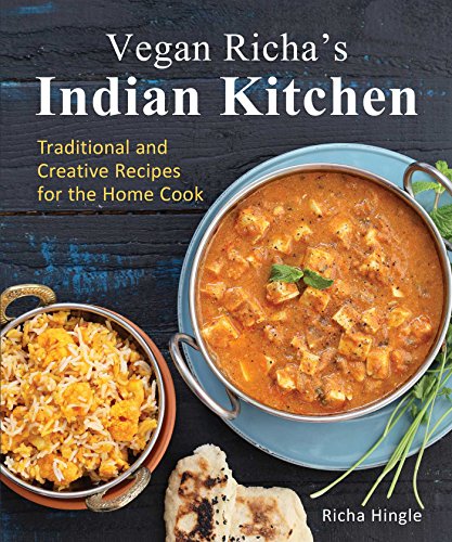 Cookbook cover featuring a bowl of curry, rice, and flatbread on a dark surface.