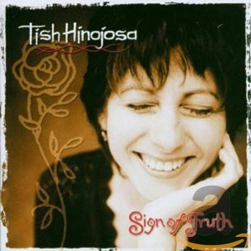 CD cover featuring a smiling woman with dark curly hair and floral design.