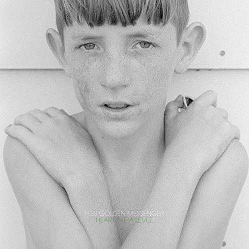 Black and white portrait of a young boy with freckles, album cover.