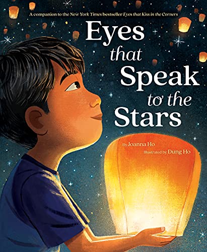 A young boy looks up at a starry night sky while holding a glowing lantern.