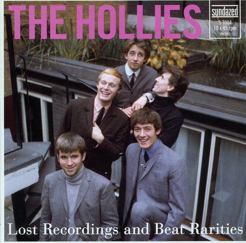 The Hollies band members posing in suits on an outdoor staircase.