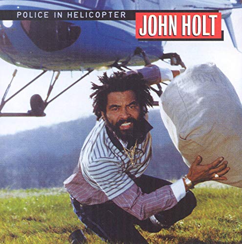 John Holt album cover: man with helicopter and large bag.
