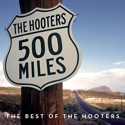 A road sign reading The Hooters 500 Miles attached to a post by a highway.