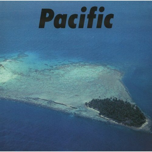 Aerial view of a tropical island surrounded by turquoise ocean.